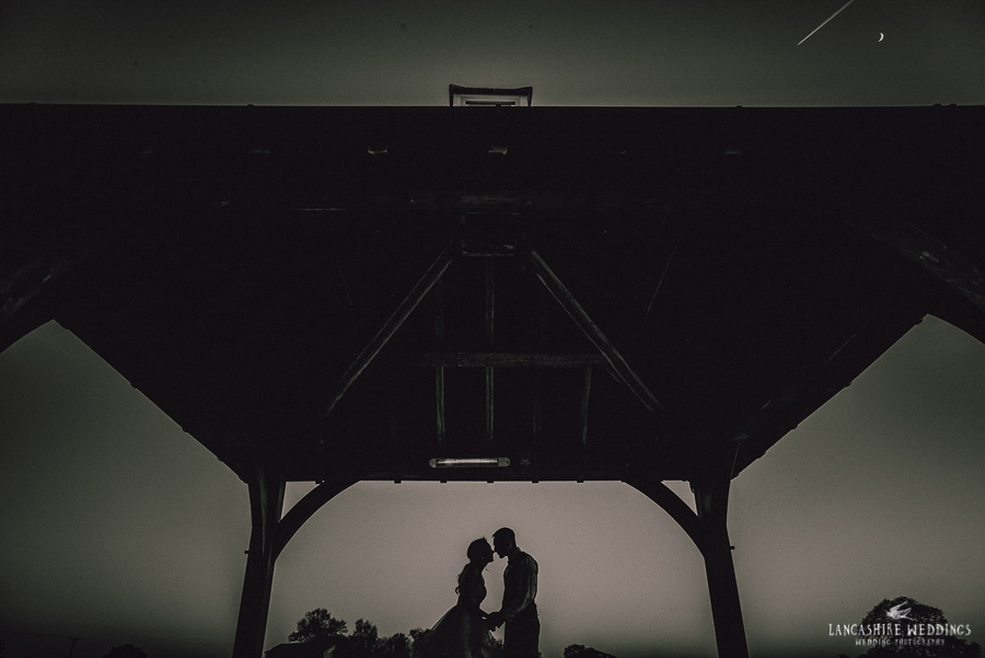 Night-time photo of happy couple at Sandhole Oak Barn