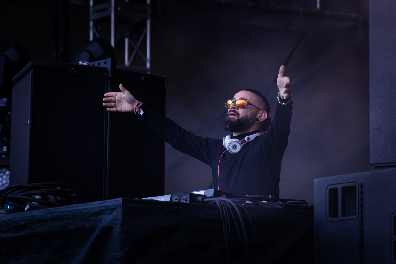 dj Skrillex with his arms raised to the crowd at Detroit Movement 2023
