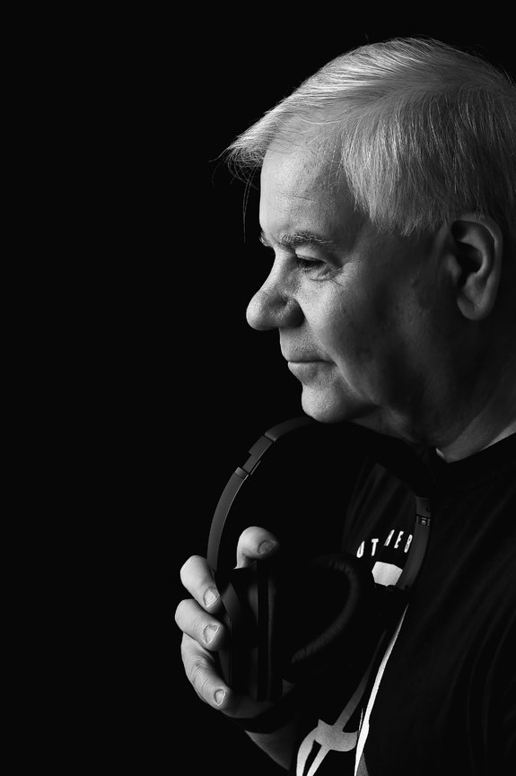 Elderly man with headphones, side profile, black and white photo.