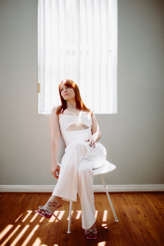 Natural Light photography portrait in white pants and blouseStyled portrait of Janel downtwon and with art mural of hearts and natural light, portrait picture taken by Adam Trujillo, a Las Vegas portrait photographer.