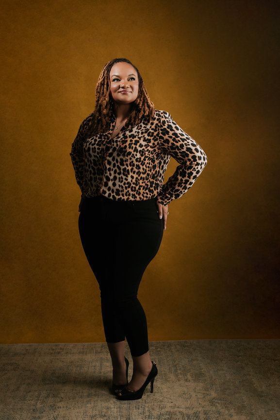 Adam Trujillo’s Las Vegas studio portraits showcase unique lighting techniques and polished beauty for stunning results. Check out the fancy leopard blouse and deep yellow orange hand painted backdrop by Adam Trujillo.