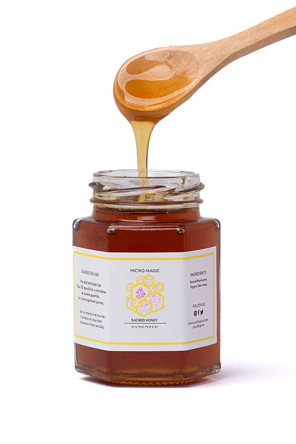 Honey in a jar with wooden spoon