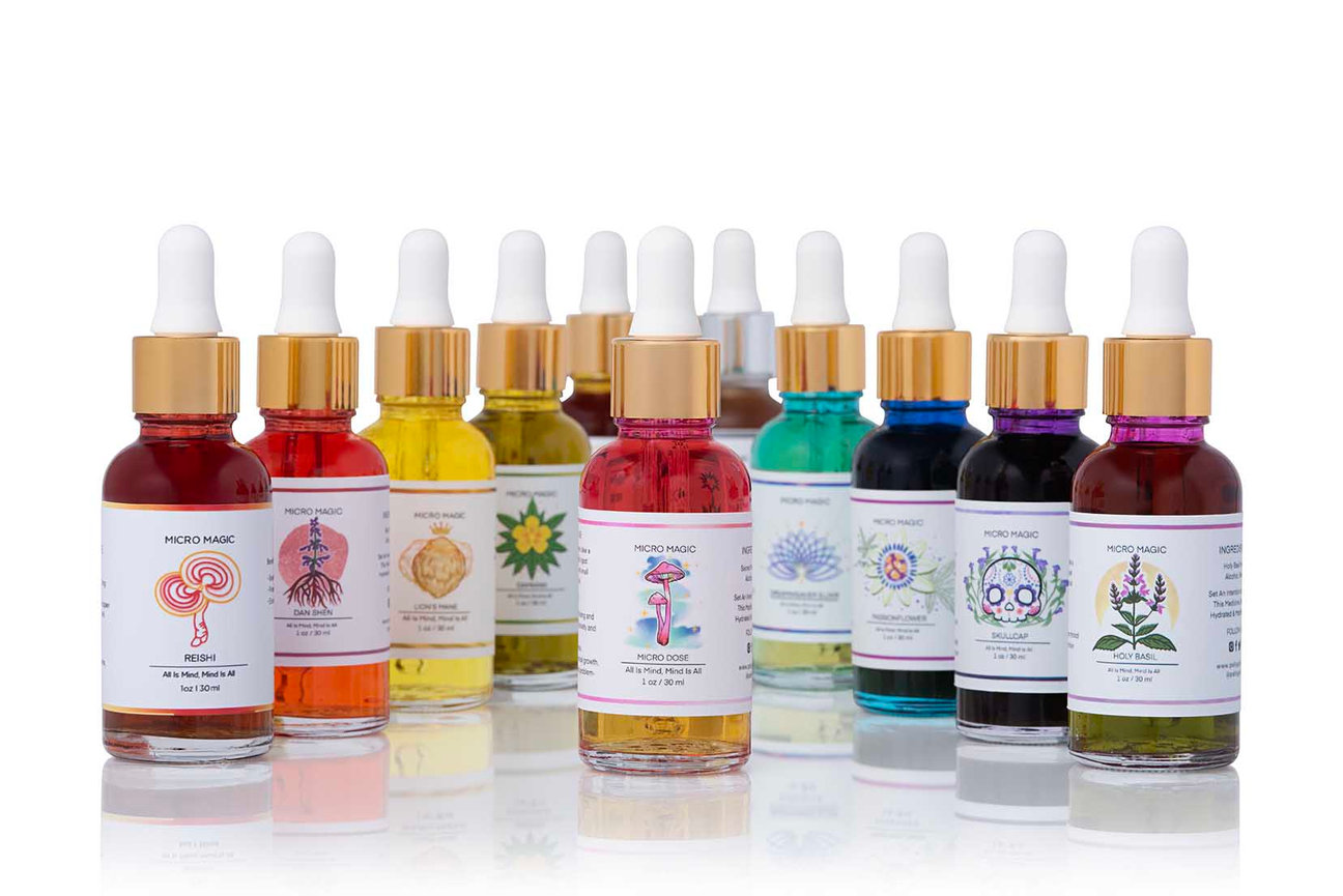 Colorful glass dropper bottles on white background