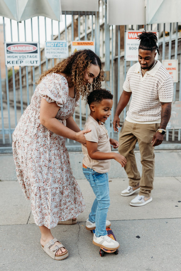 Huntsville Alabama family photoshoot Black mother helps son ride skateboard
