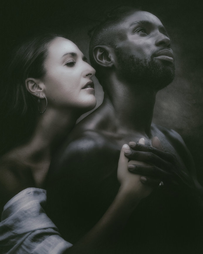 Fine Art Painterly Intimate portrait of a couple embracing in moody black and white tones