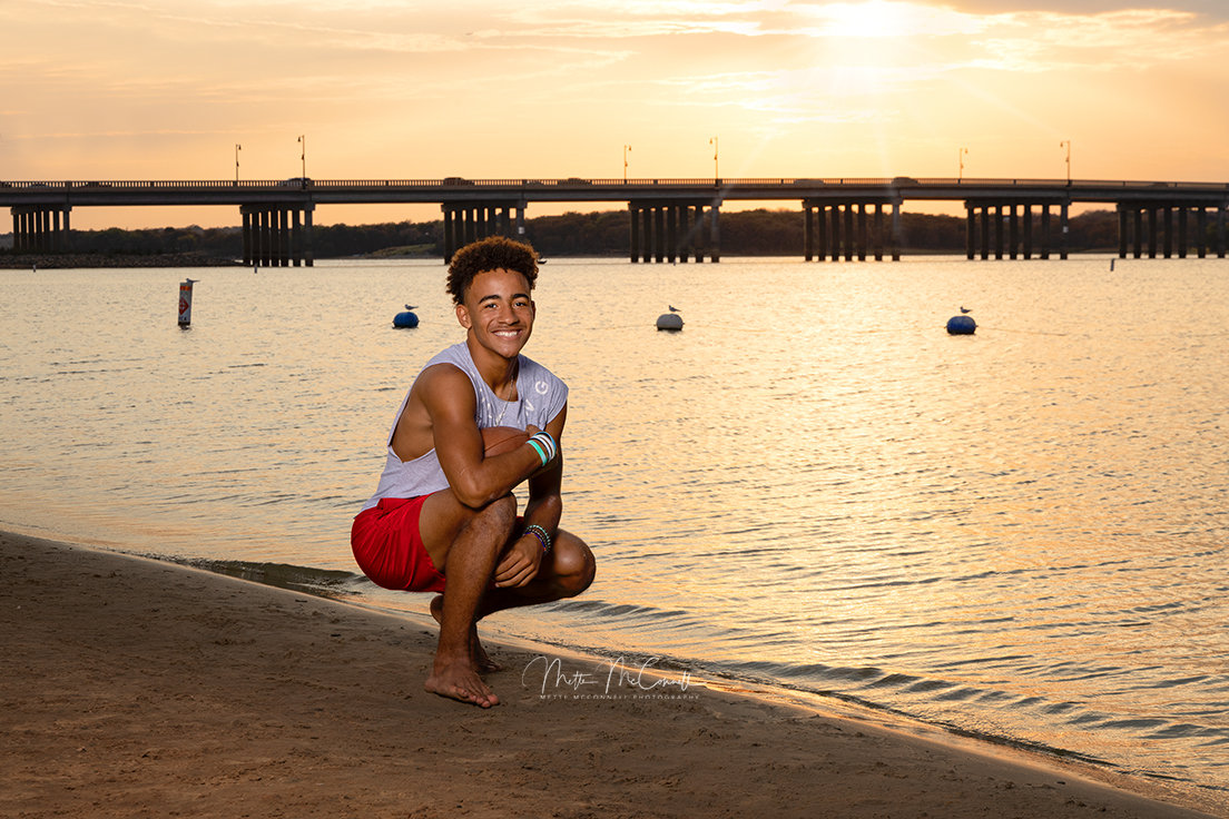 High school senior picture on little elm beach sunset