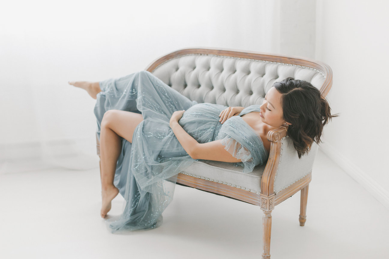 Pregnant woman in blue dress in a Minneapolis studio photo session