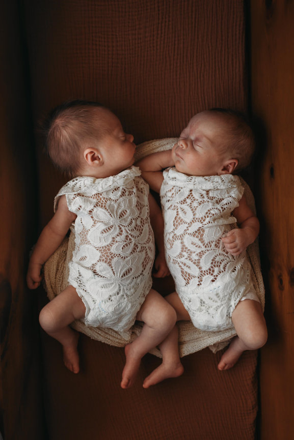 Newborn twins laying together in cradle in a New Jersey Newborn Photography Studio.
