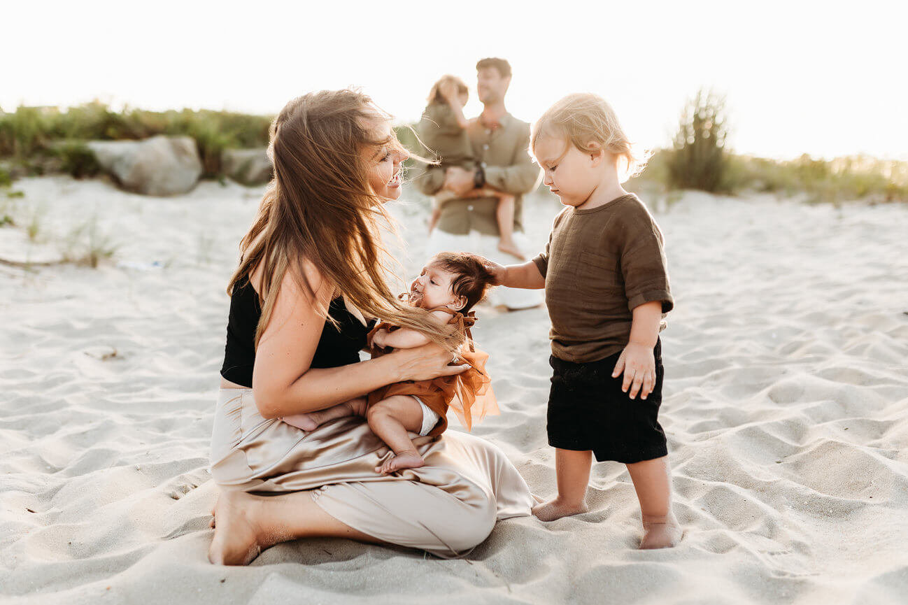 A family on the beach in Sandy Hook, New Jersey during their sunset photography session.
