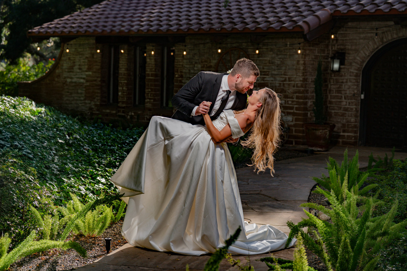 Bride and groom in elegant sunset dip