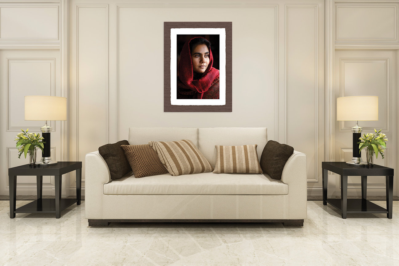 framed portrait artwork displayed above sofa in a refined living room setting designed for the home