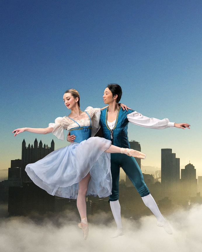 Two ballerinas dancing in flowing dresses against a city skyline at sunset.