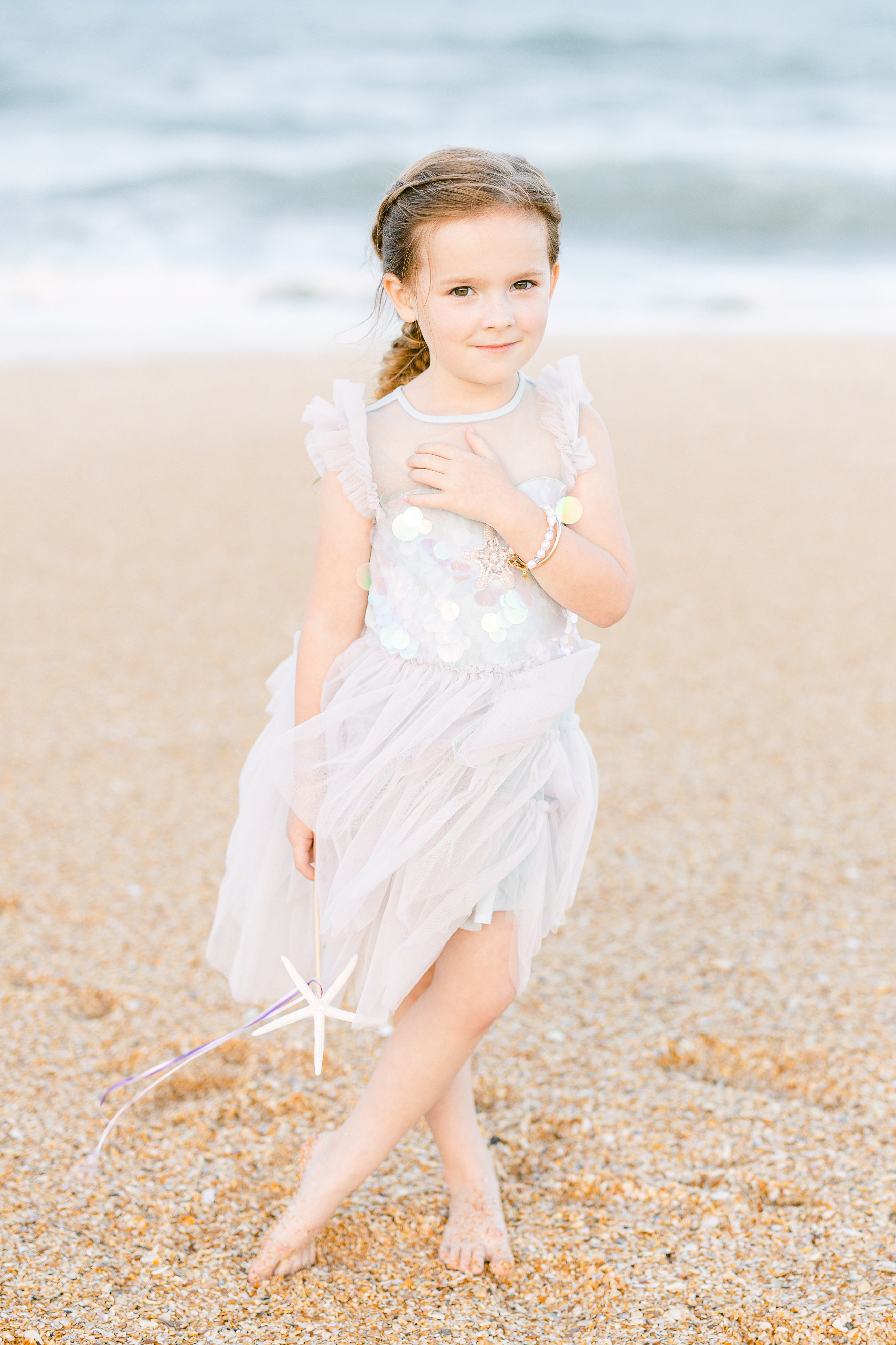 pastel colorful mermaid inspired portrait of a little girl by the sea