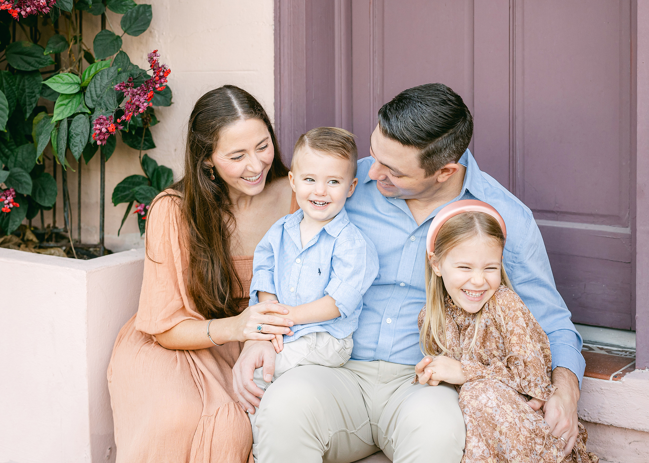 Family sitting together on the steps on Aviles Street in downtown Saint Augustine, Florida.