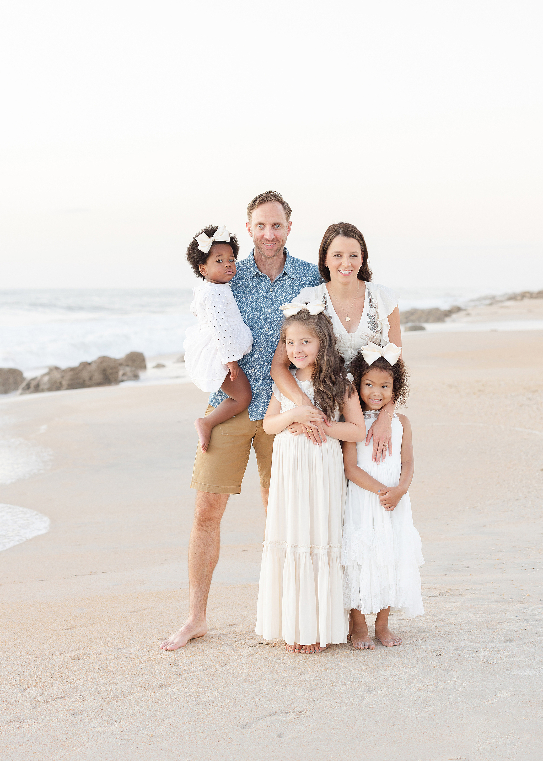 A light and airy family beach portrait of a blended family of five on Saint Augustine Beach.