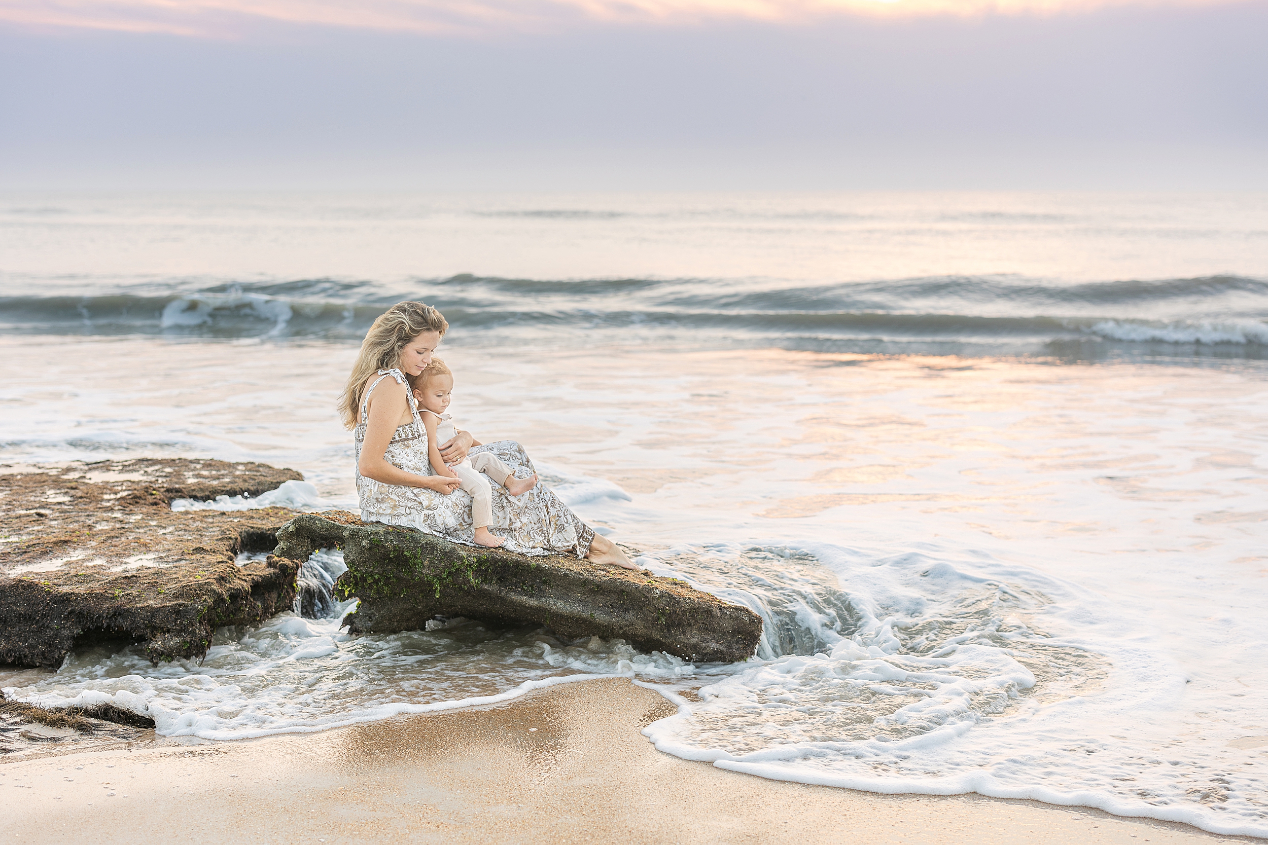 A sunrise motherhood portrait on St. Augustine Beach.