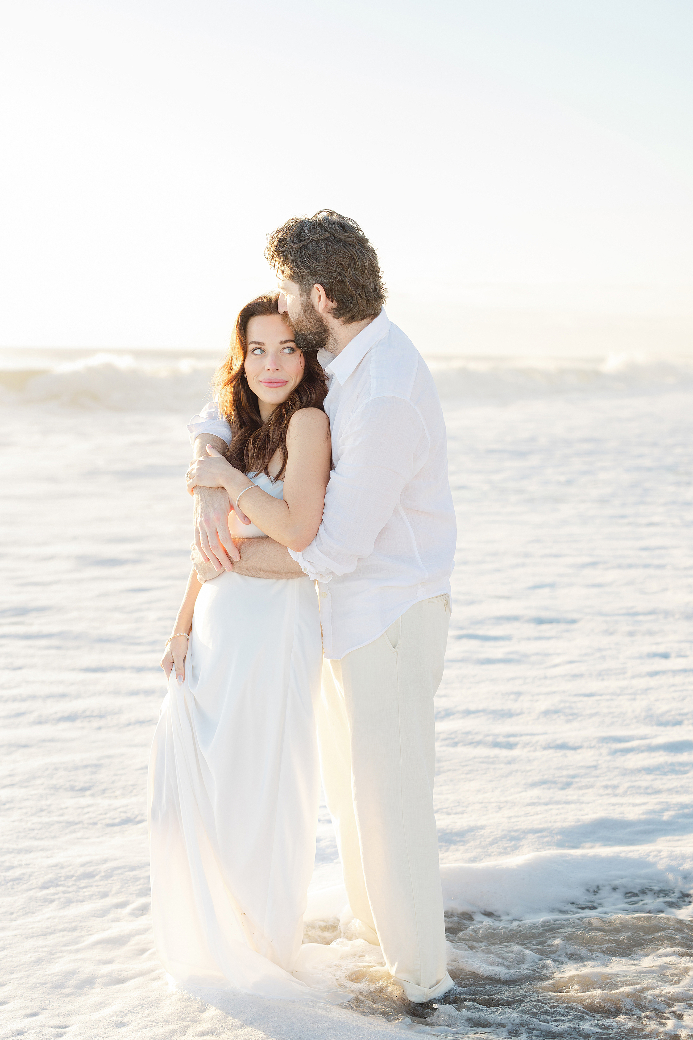 Sunrise destination wedding portrait of a man and woman on the beach of the Omni Resort, Amelia Island.