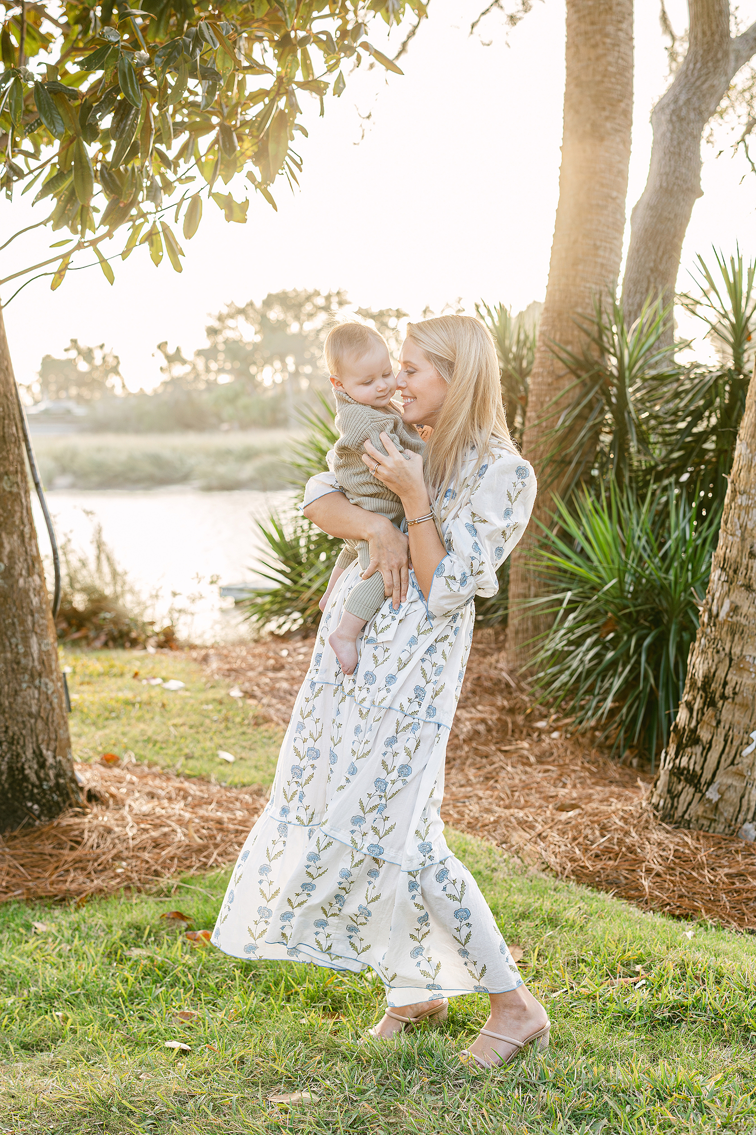 A sun filled motherhood portrait of a baby boy with his mother on the banks of the intracoastal at Sea Island Resorts.