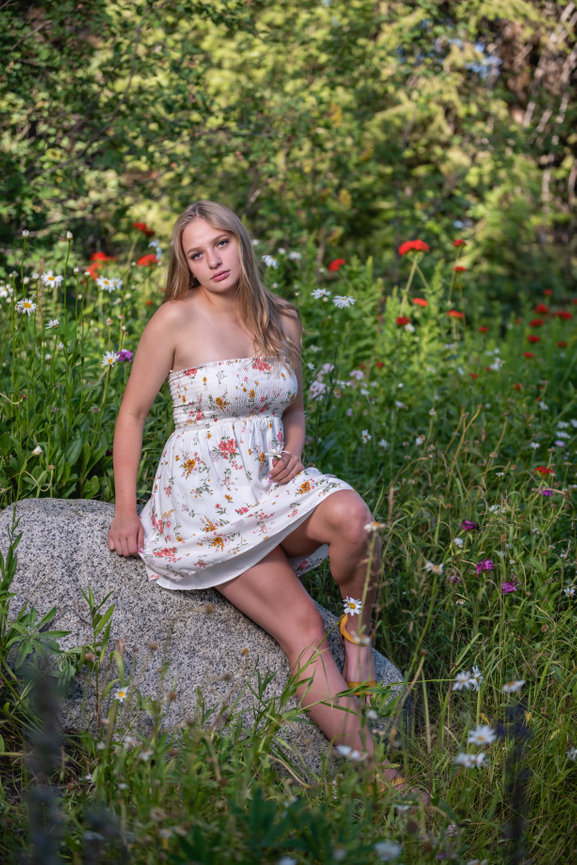 Senior year girl sitting in wildflowers. McCall, Idaho