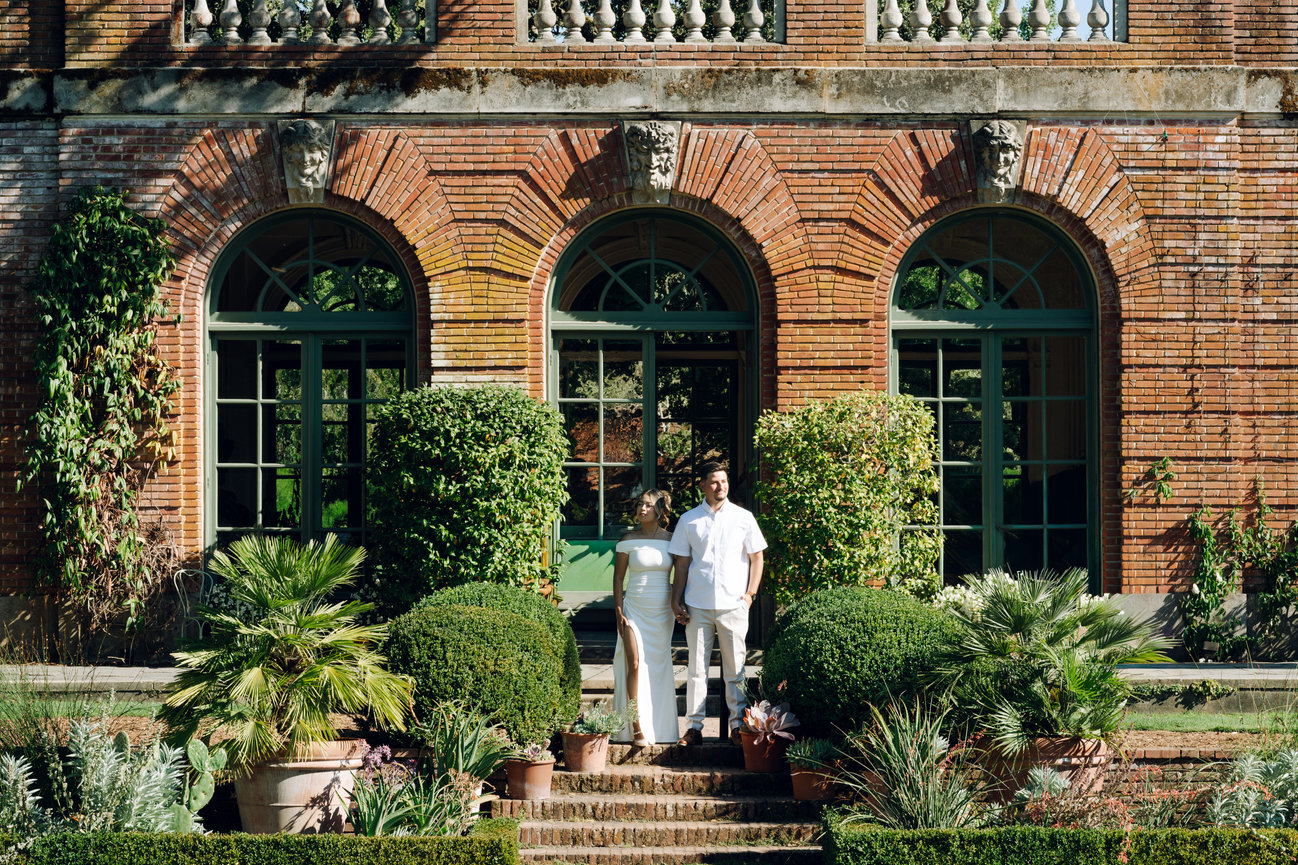 Couple standing in front of a villa