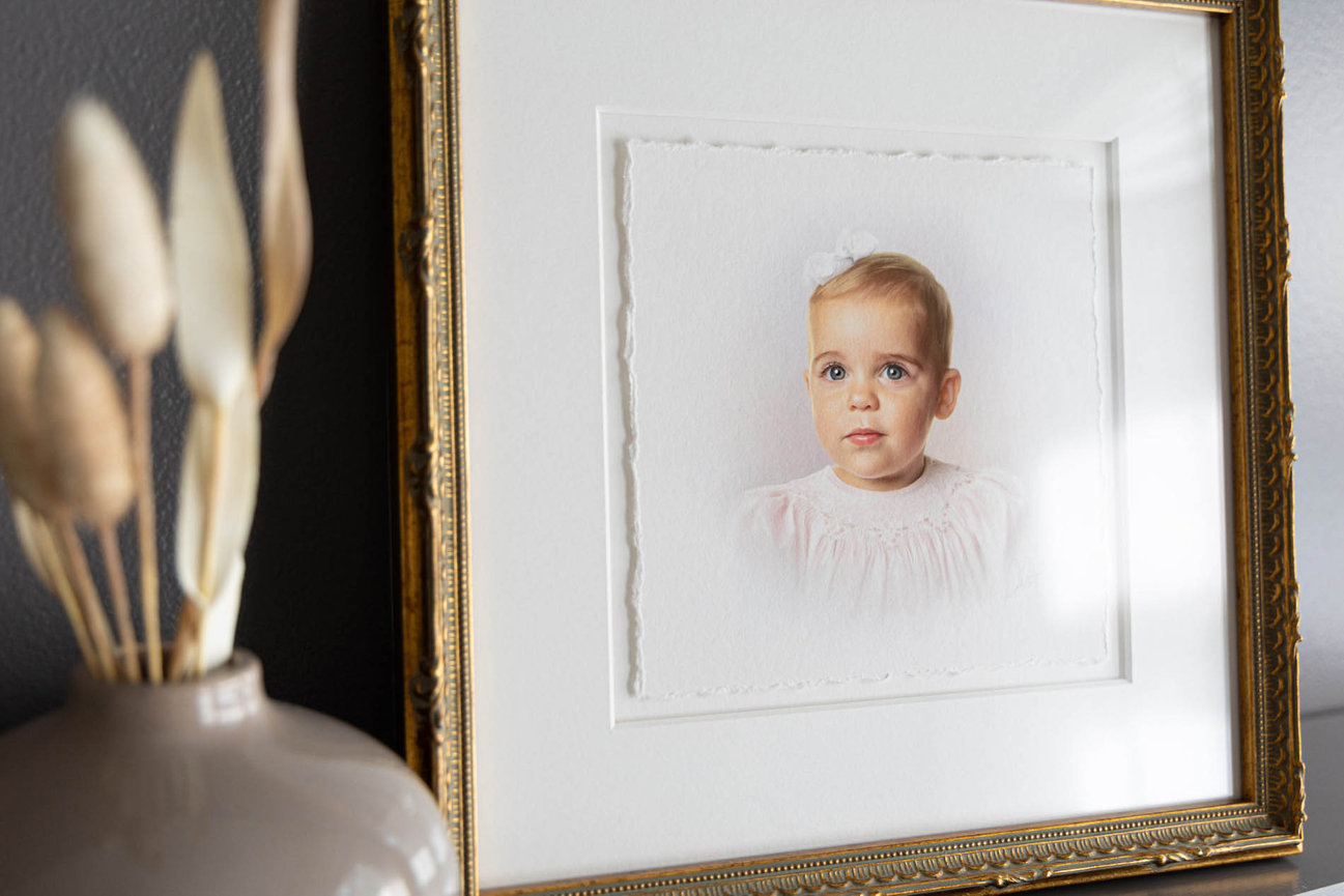 Soft pastel portrait of a young girl in a pale dress, captured in heirloom head and shoulders style.