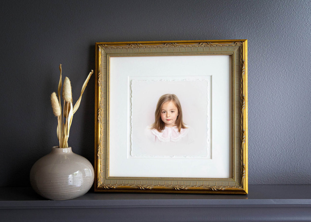 Soft pastel portrait of a young girl in a pale dress, captured in heirloom head and shoulders style.