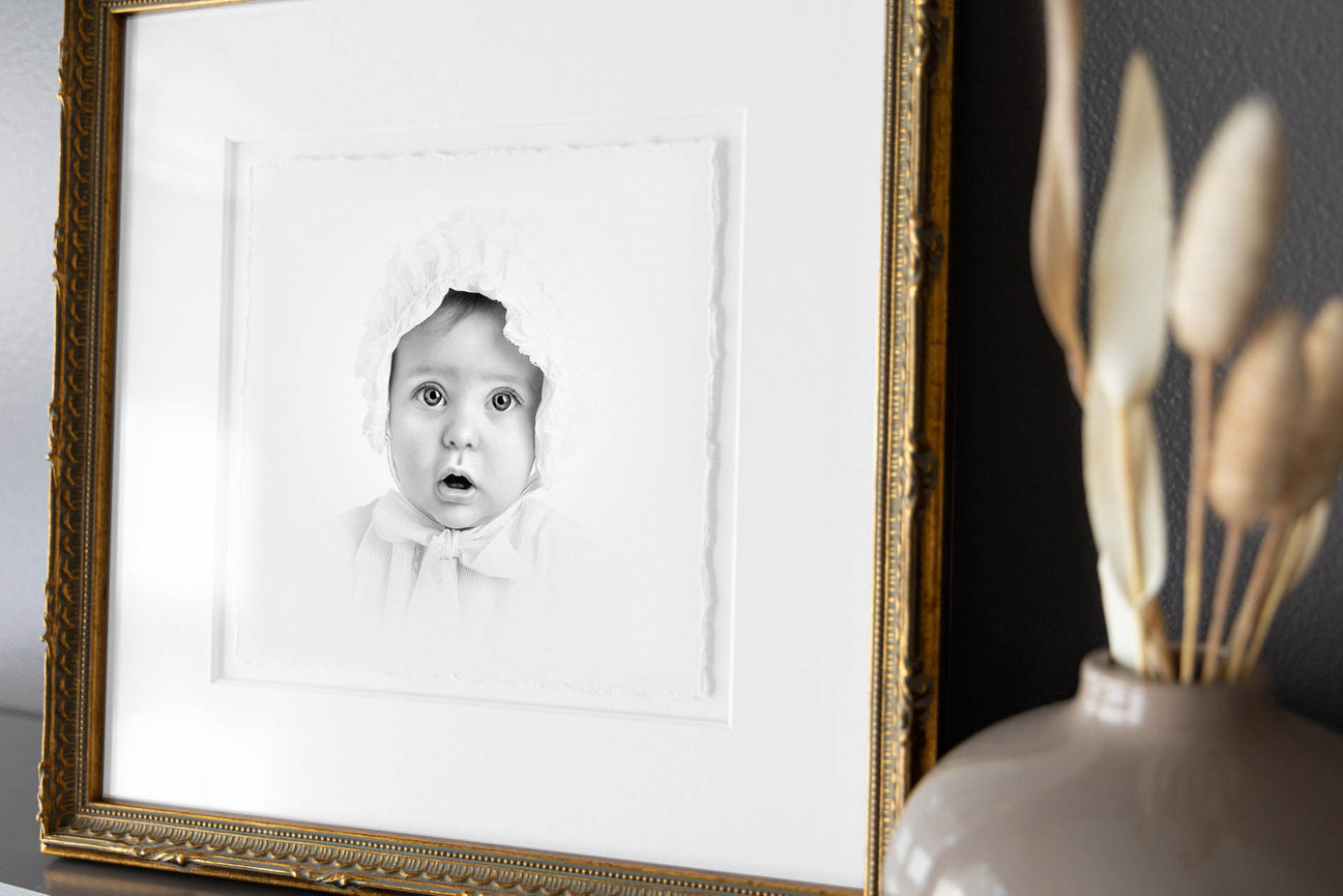 Monochrome heirloom portrait of a young girl in traditional dress, hand-finished charcoal detailing.
