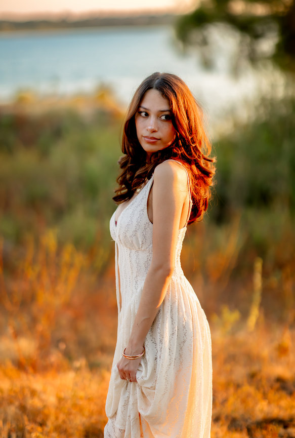 Woman in a white lace dress standing in golden grasses by the water, Llano, TX portrait photography