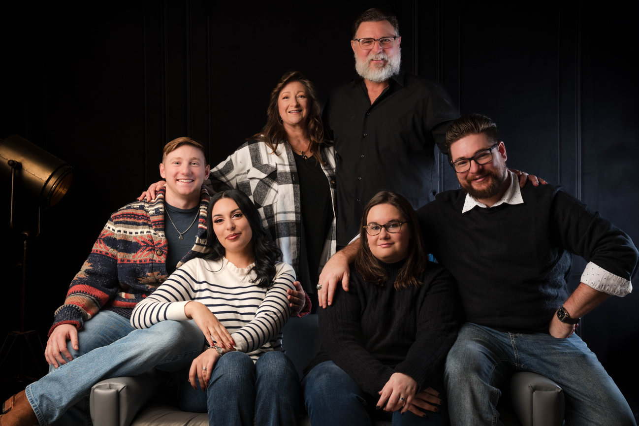 Family portrait session at West Texas Times Photography Studio in Lubbock, featuring six family members posed together in a professional studio setting.