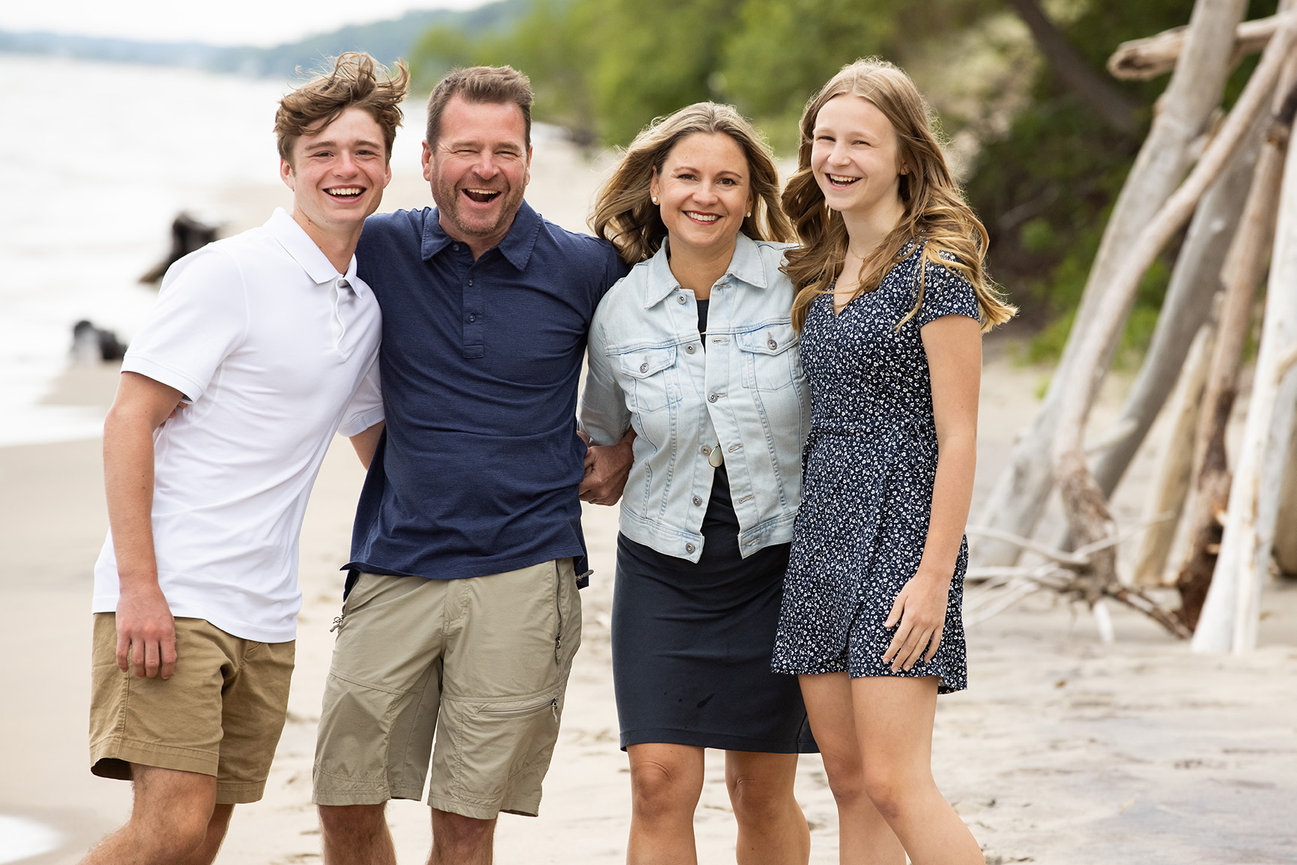 A family of four on the shores of Lake Michigan in Grand Haven