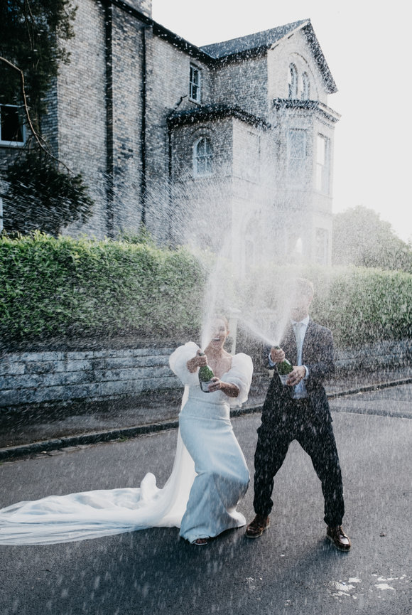 Editorial wedding photography bride & groom champagne spray celebration at The Bowden Rooms, Altrincham.