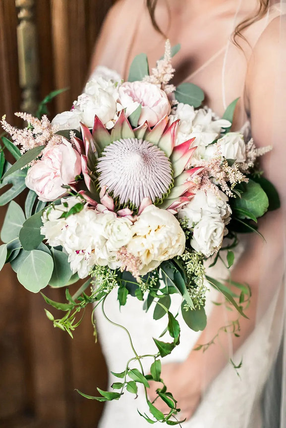 Bridal bouquet with protea and roses
