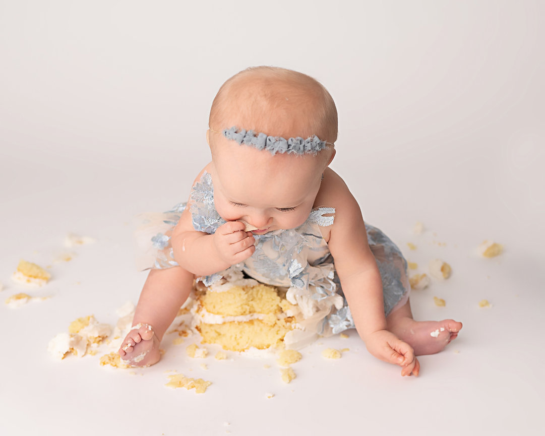 Messy cake smash with baby joyfully covered in icing in Point Pleasant