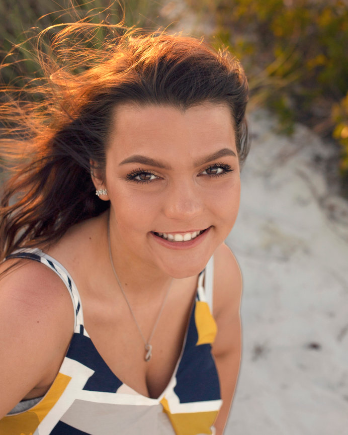 High school senior girl at her beach destination senior photoshoot with Angie Vincent at Heart to Art Photography.