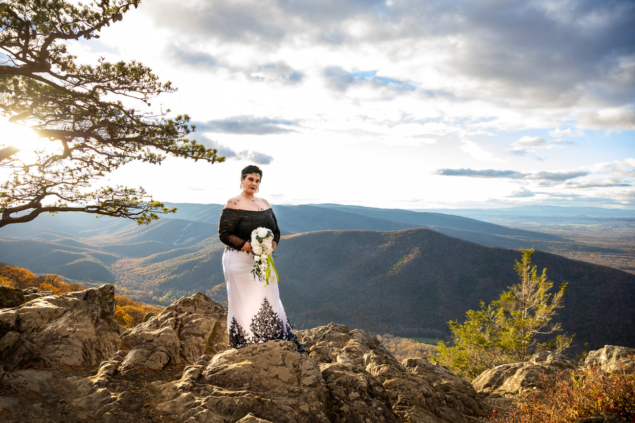 Bride standing on a mountain with scenic view