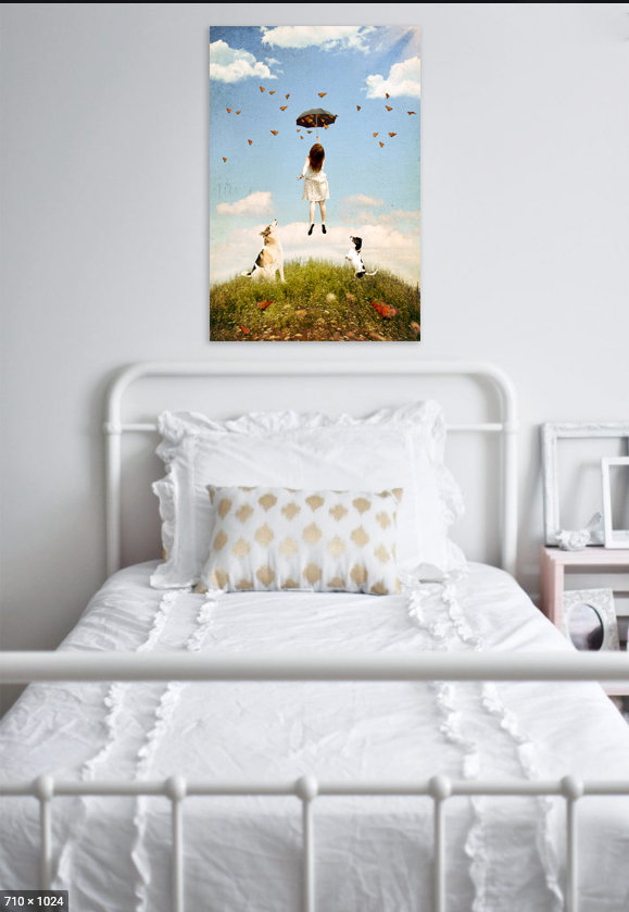 A wall portrait of a girl with her two dogs hangs in her bedroom