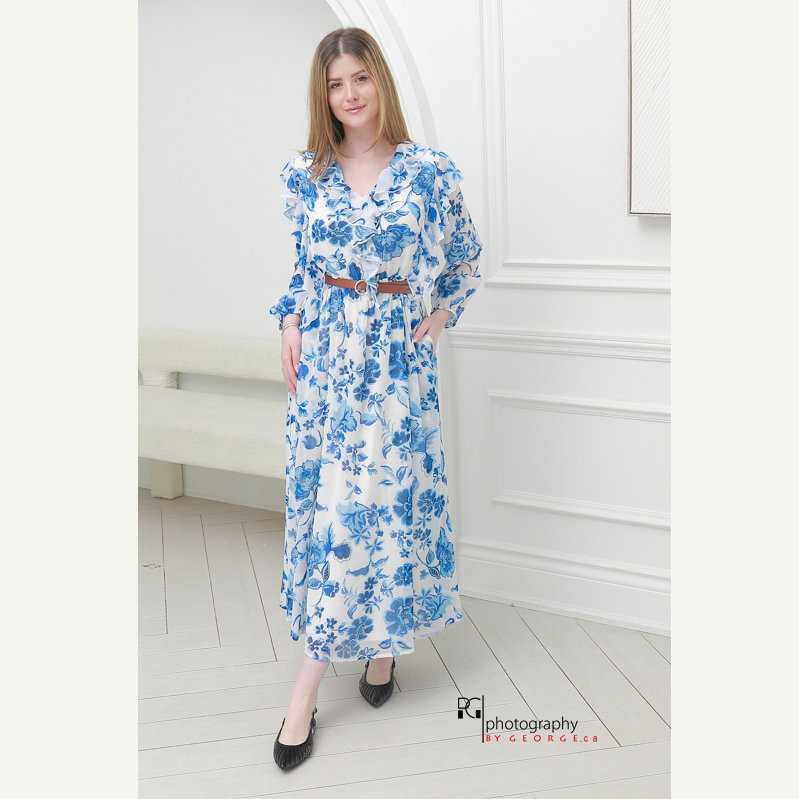 Model wearing blue floral midi dress photographed for Spring Summer 2026 fashion lookbook.