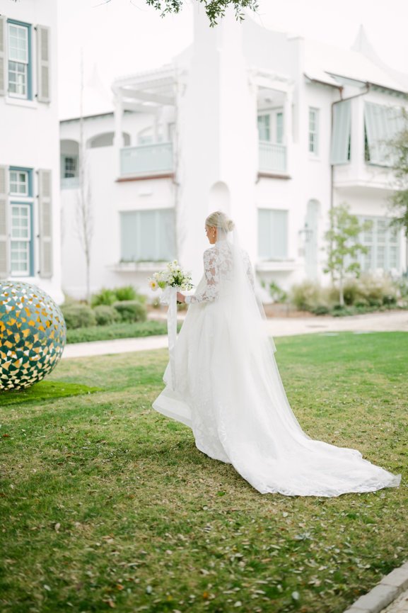 Bride walking across the lawn at Alys Beach by Heather Durham Photography