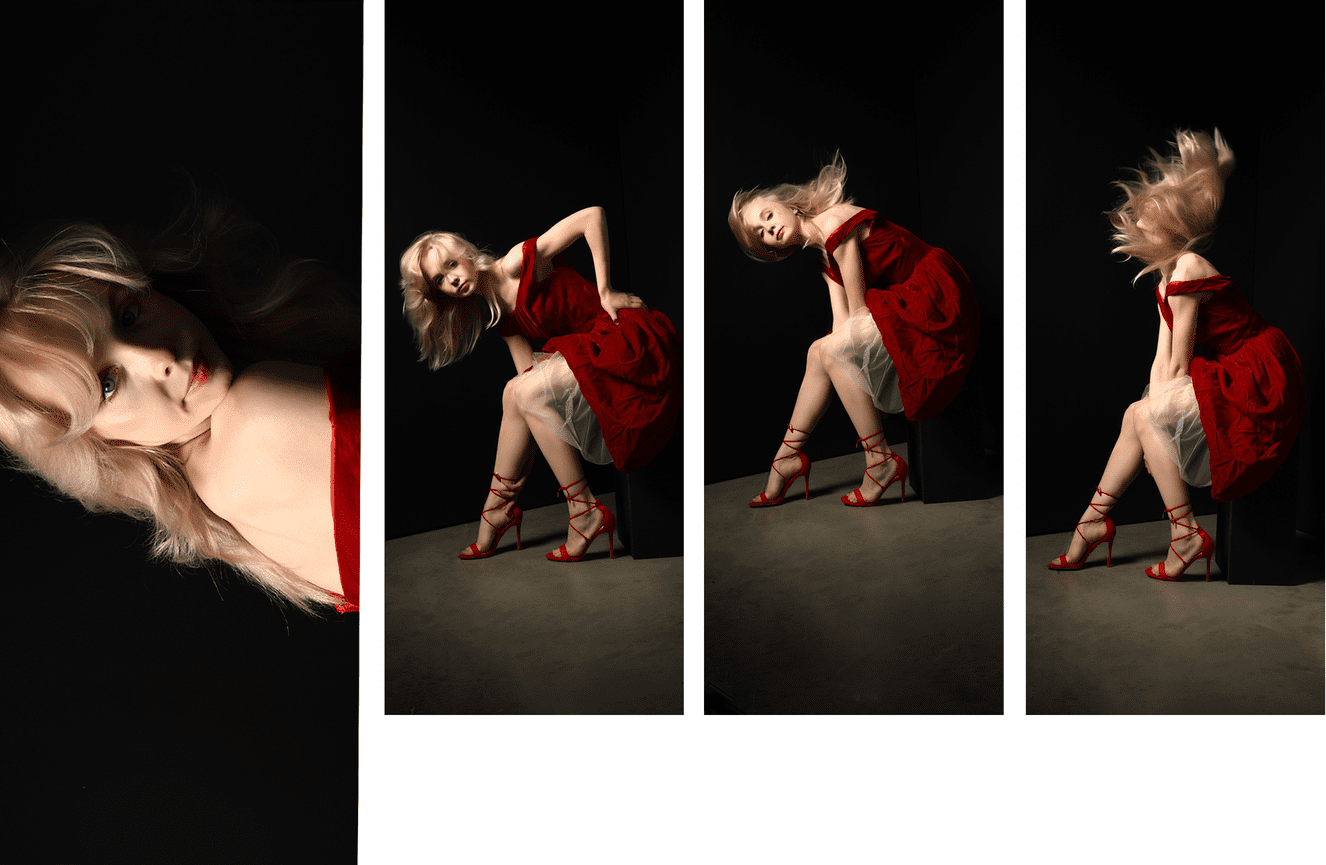 A high school senior flipping her hair while wearing a ruby red velvet vintage gown at Kliks Photography.