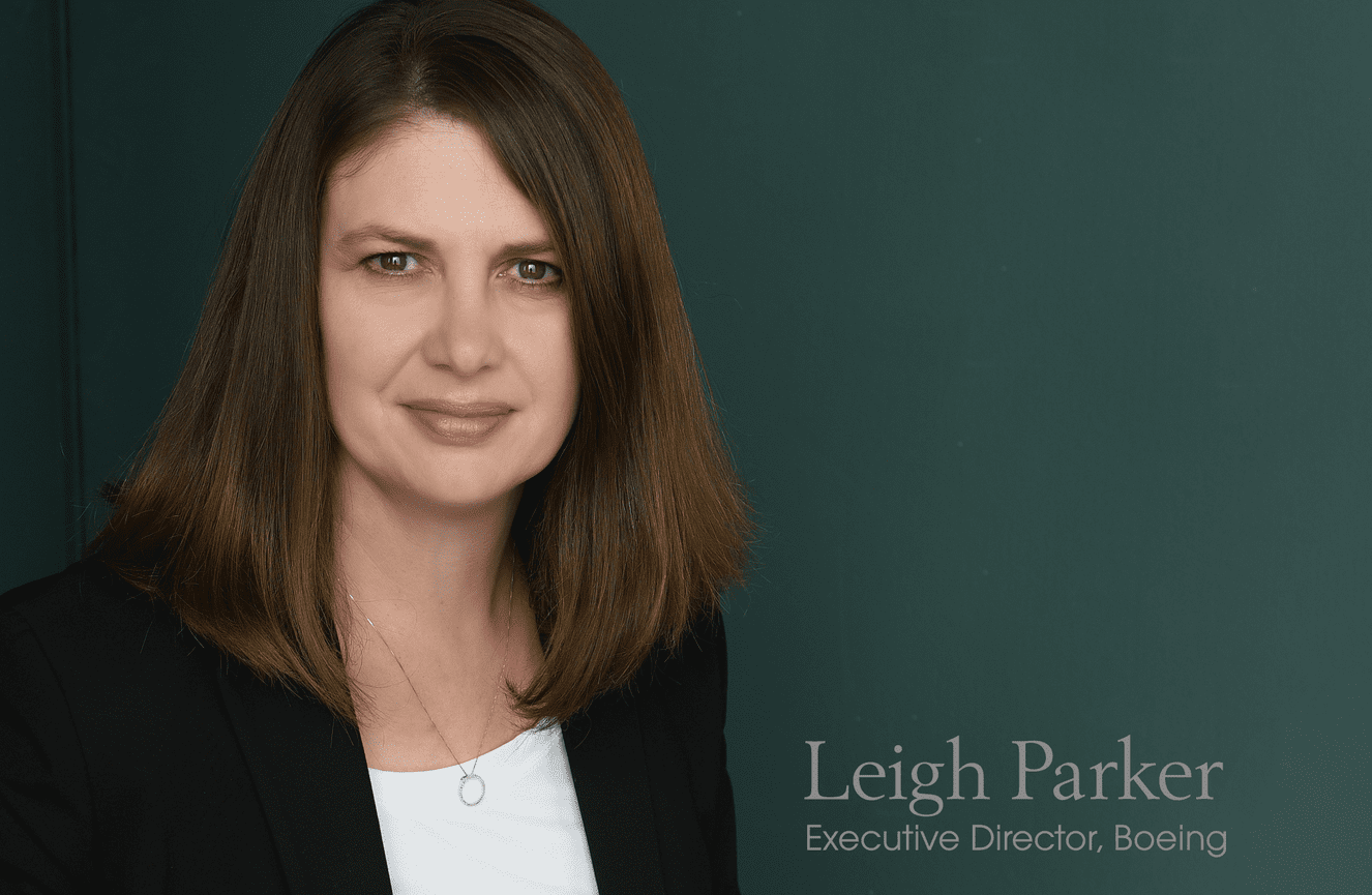 Leah, an executive director of Boeing, poses in her black suit for a headshot at Kliks Photography.
