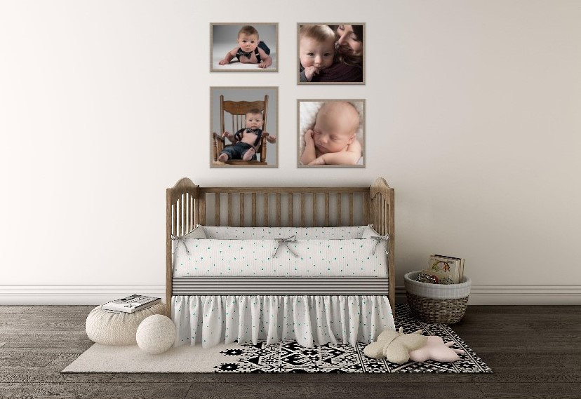 Nursery with a wooden crib, soft bedding, plush toys, and framed baby photos on the wall.