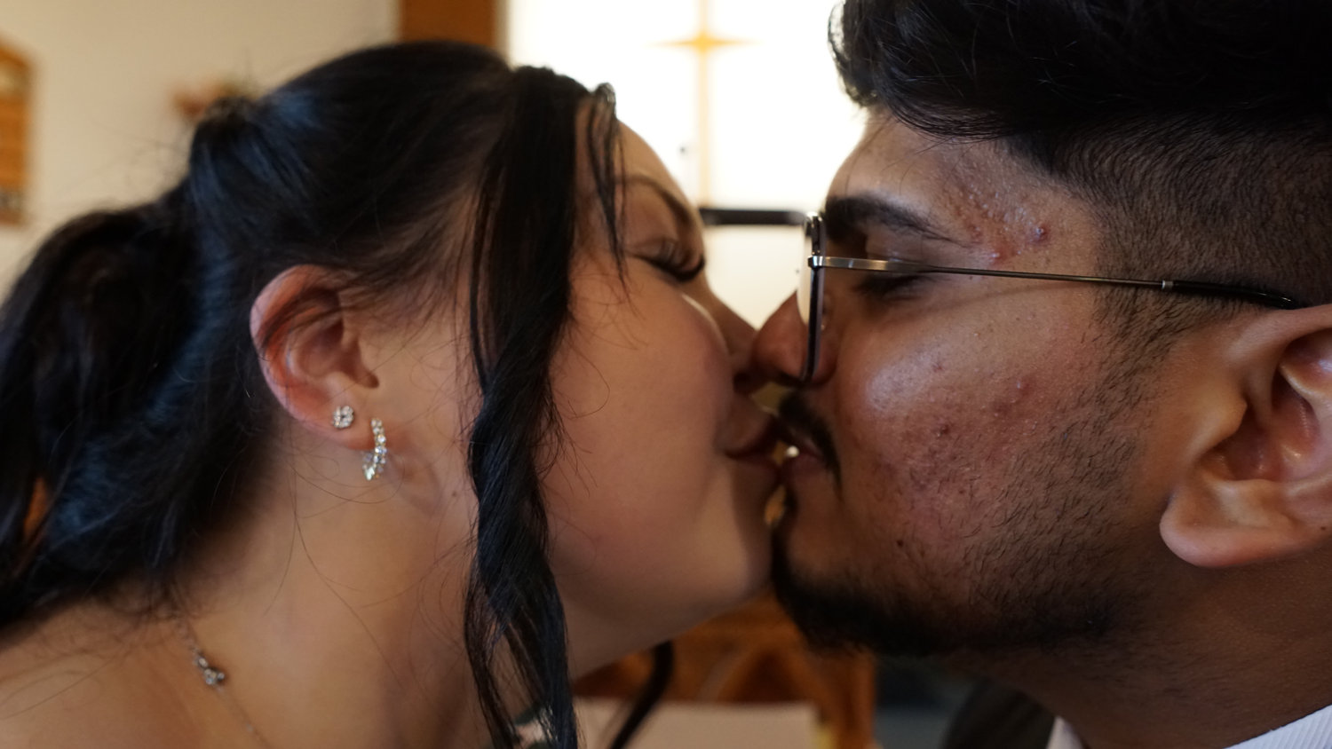 Close-up of bride and groom kissing at their wedding