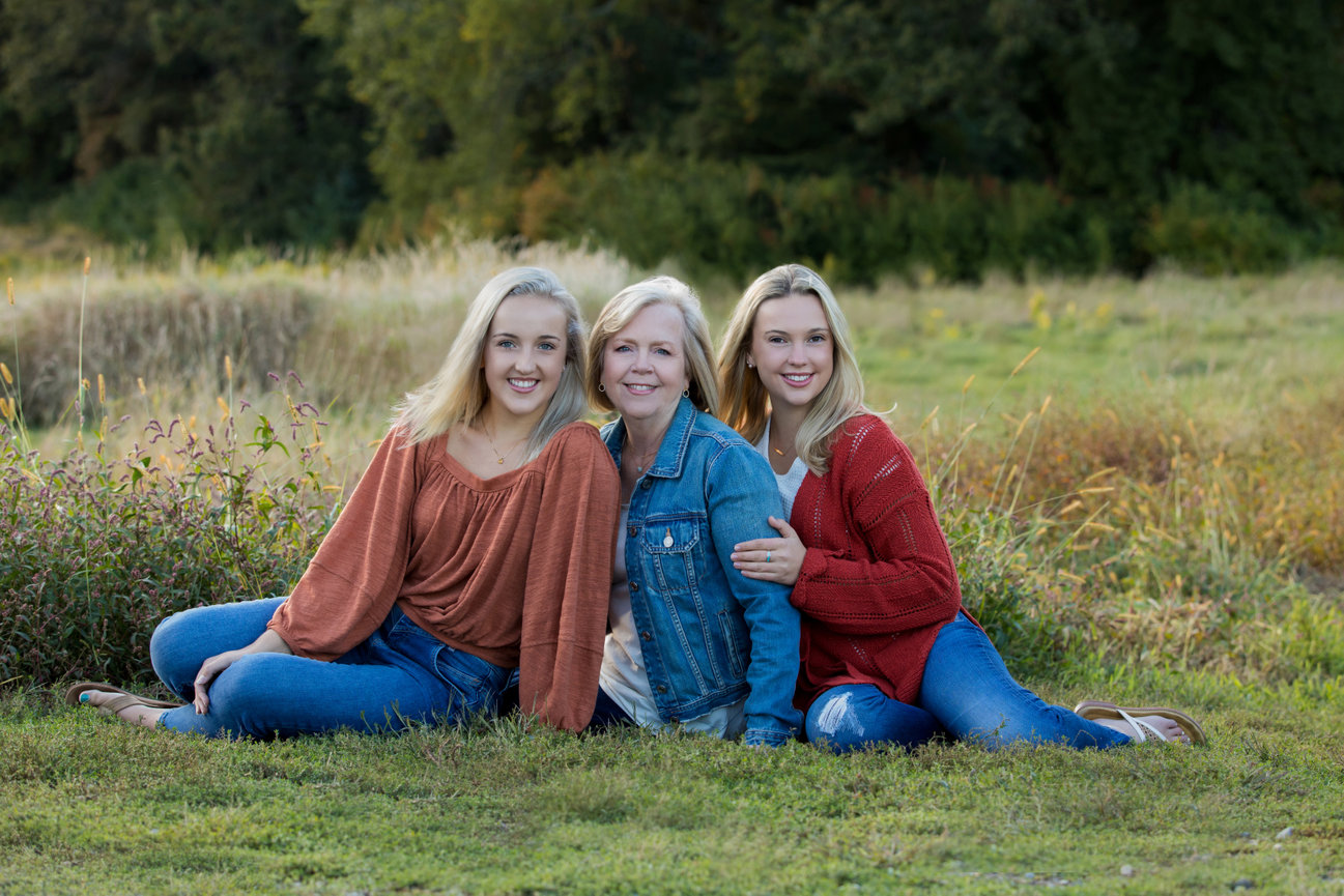 outdoor family portrait with single mom and two young adults daughters in field during fall medfield ma