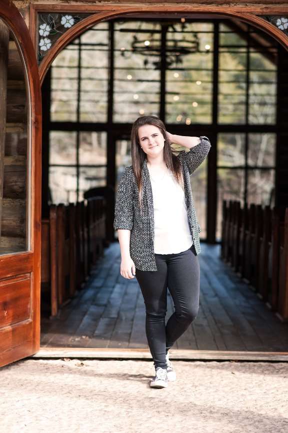 senior girl standing in front of Hope Wilderness Chapel at Dogwood Canyon