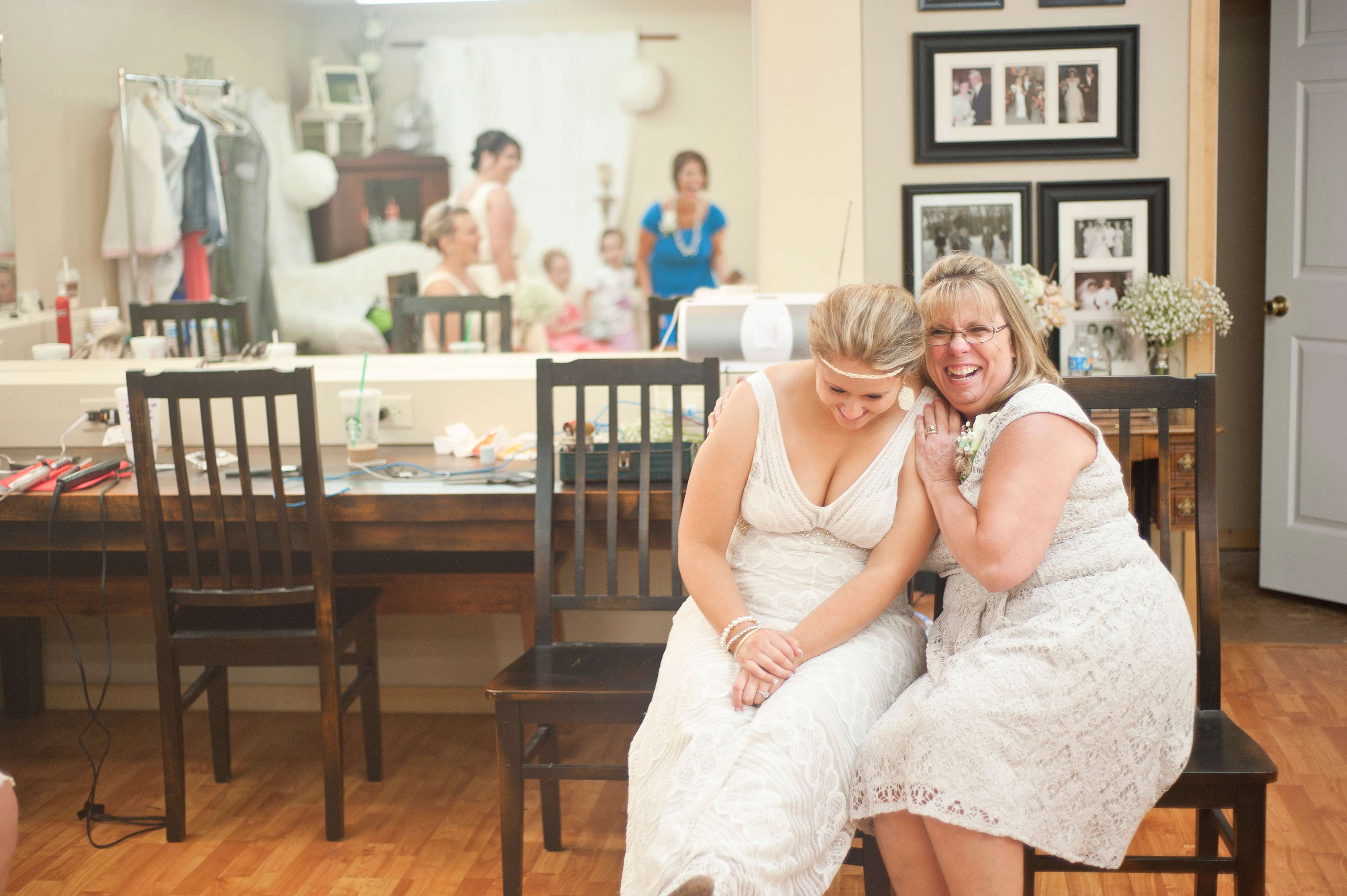 Bride laughing with future mother-in-law before the wedding.