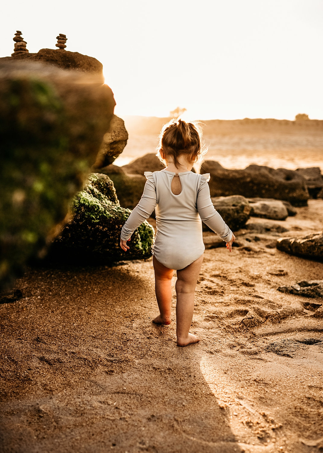 toddler girl walking along a rocky beach, Florida beaches, Ryaphotos