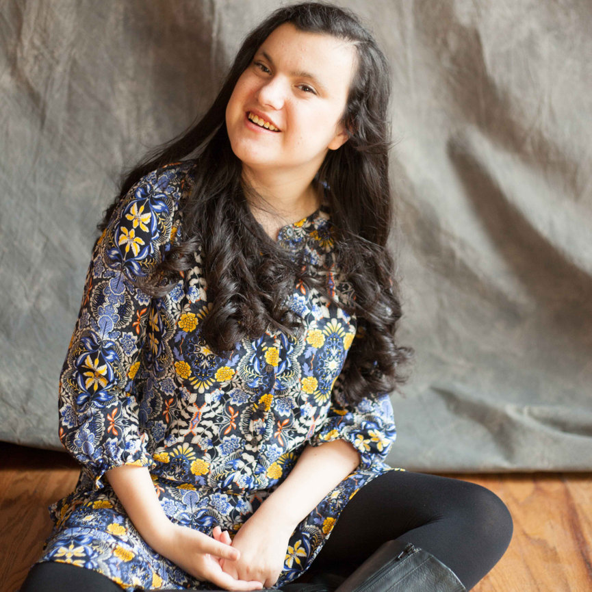 High school senior smiling confidently during a personalized in-studio portrait session. Created for families seeking a supportive, patient, and affirming luxury photography experience that honors each student’s individuality