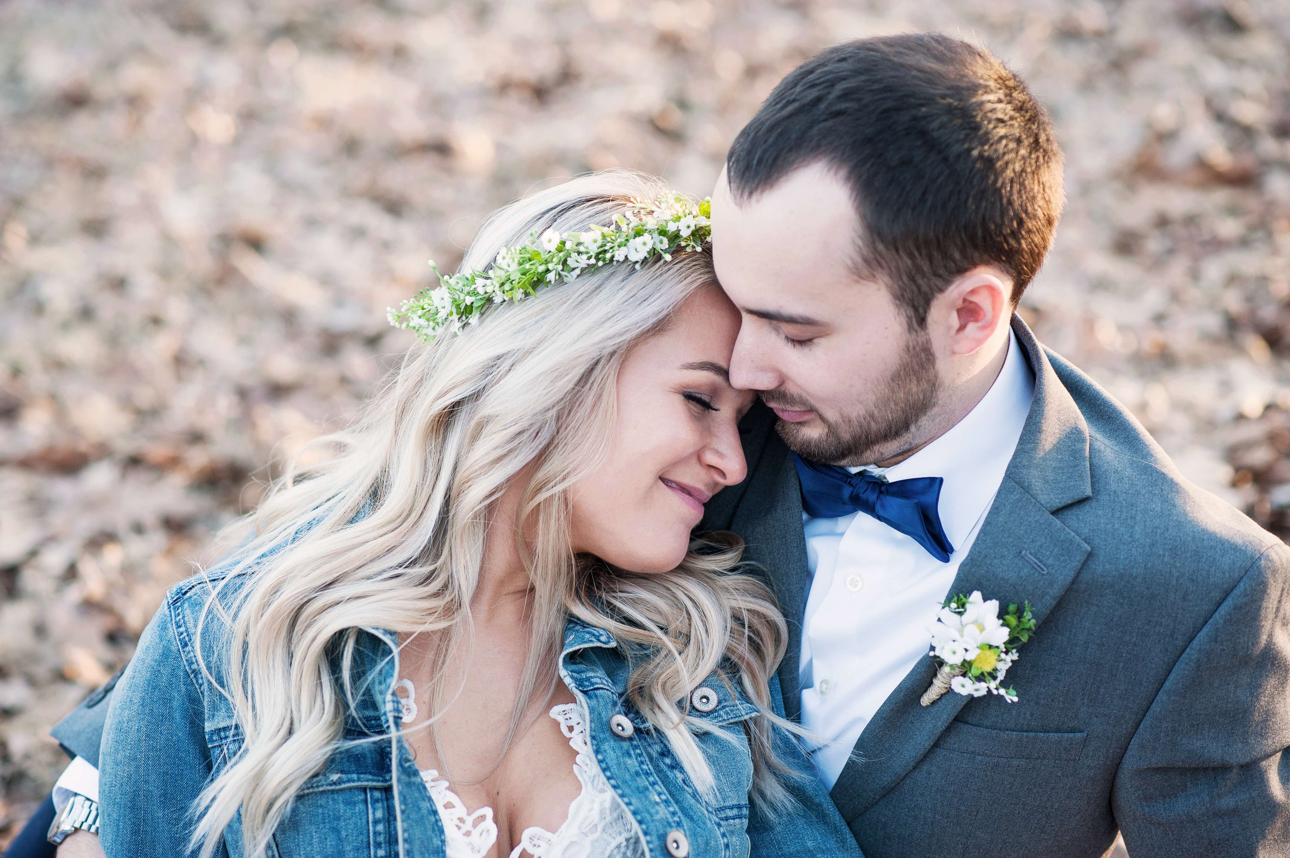 Bride leaning back on her groom at the end of their wedding day.